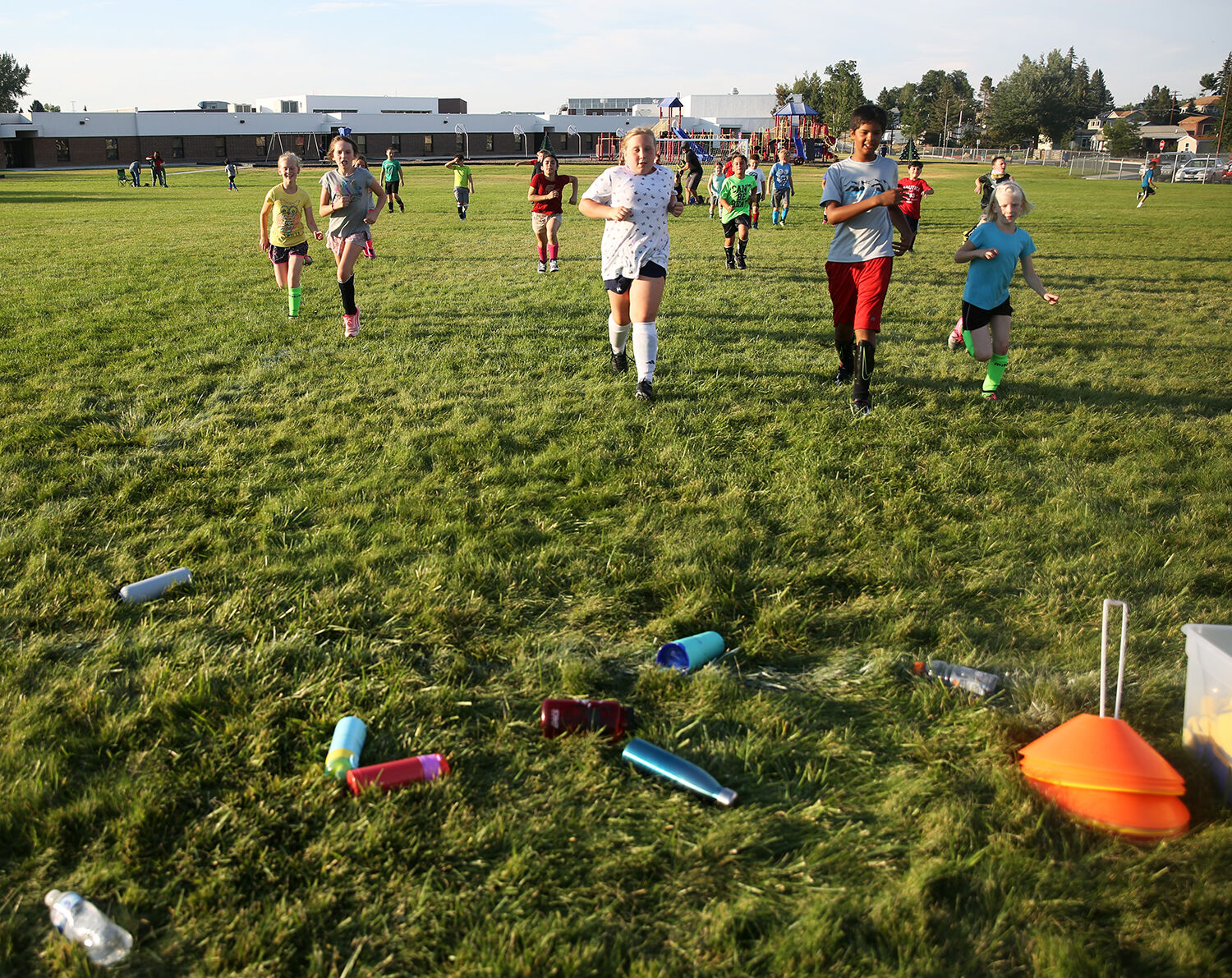 The third through sixth graders run back to their water bottles